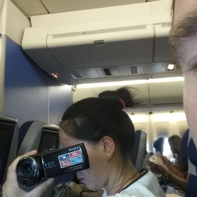 this woman filmed the inside of the plane, leaned over me to film the take off, and landing.