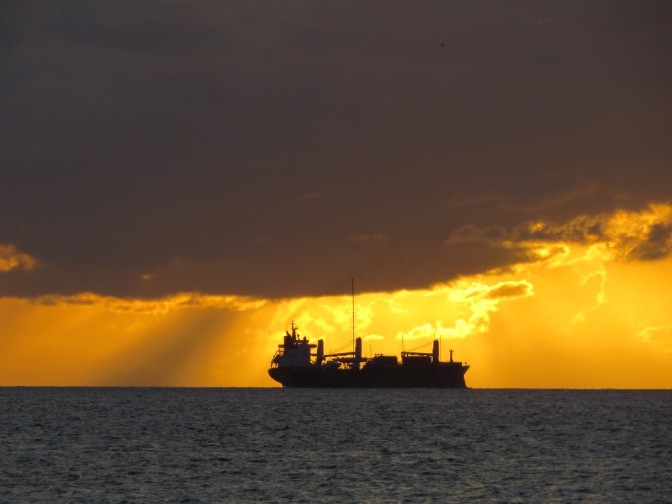 Sunset with cargo ship