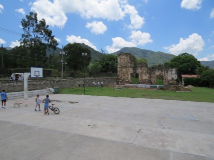 Kids playing in front of a ruin under restoration. Such a contrast.